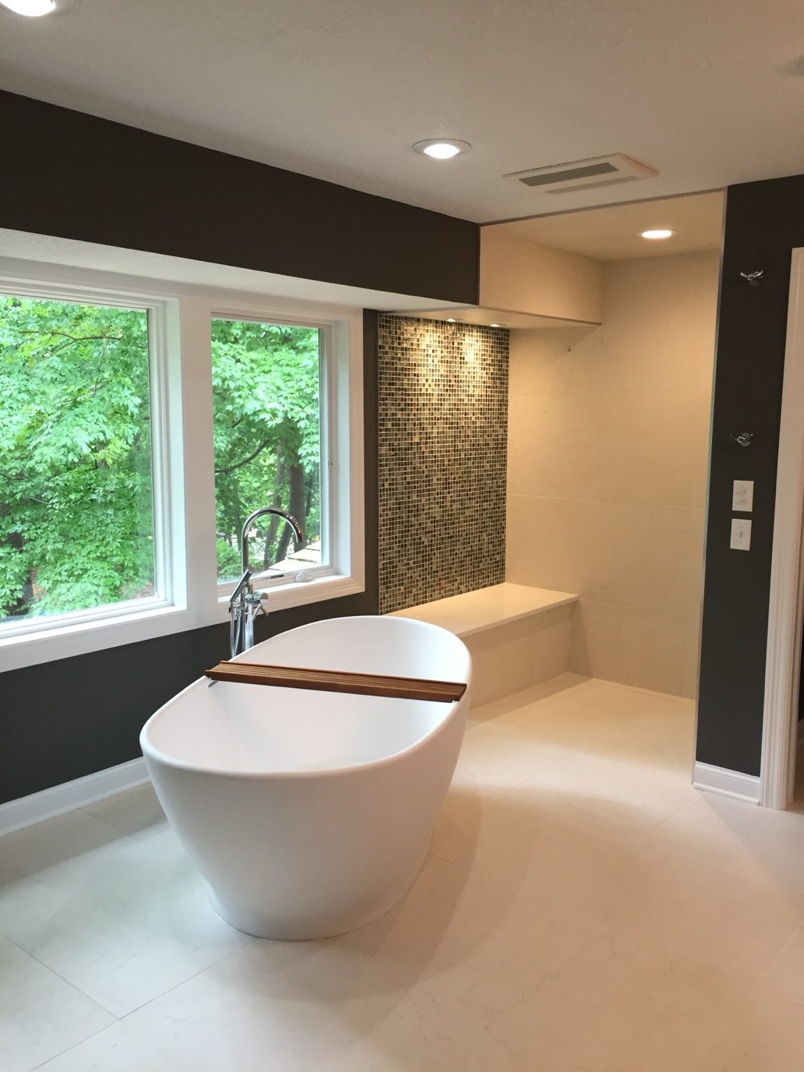 Old Stone Tile bathroom with freestanding tub and tiled shower